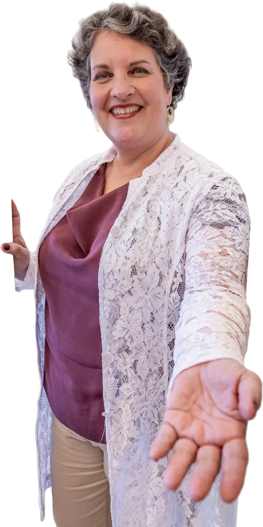 Dra. Patrícia, de blusa vinho e casaco de renda branca, sorri e estende a mão em direção a quem vê a foto.